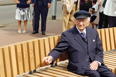 Ben Ferencz sitting on the bench donated by him in front of the Peace Palace