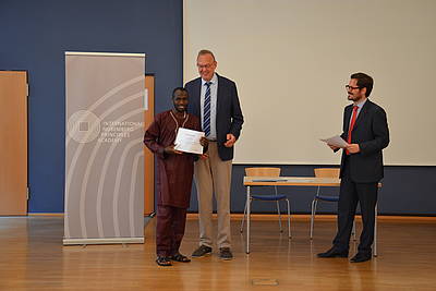 Mr. Klaus Rackwitz, Director of the Nuremberg Academy presents the certificate of participation.