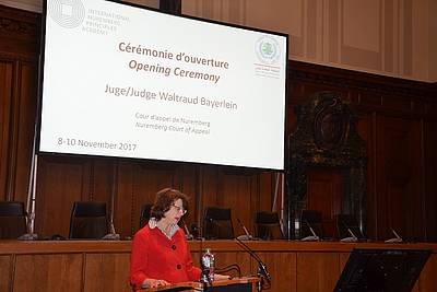 Judge Waltraud Bayerlein, Nuremberg Court of Appeal, welcoming the participants in the historic Courtroom 600
